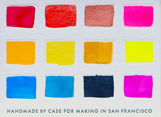 A close-up of the pre-painted swatch card for the 12-Color Watercolor Mixing Travel Palette.