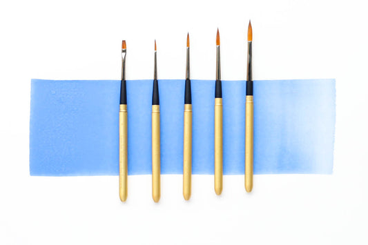 Five sizes in a row of Case for Making Matte Gold Travel Brushes. From left to right: flat size 2, round size 2, round size 4, round size 6, round size 8.