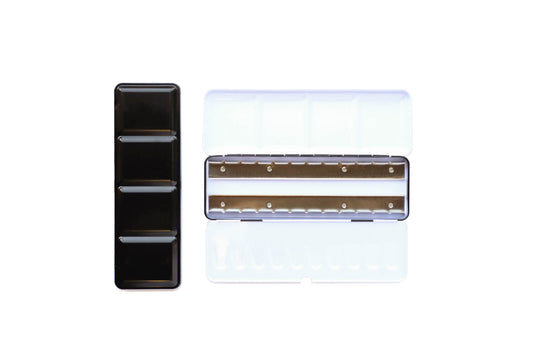 Medium Empty Palette - a closed palette beside an open palette. The exterior is shiny black and the inside is shiny white with mixing space in the lids. Interior shows 2 empty metal rows that the pans of watercolor clip securely into.
