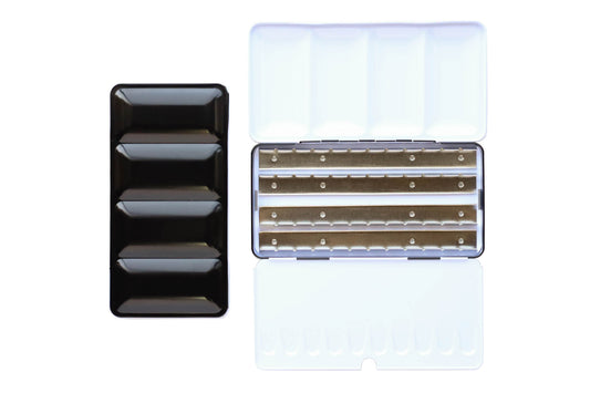 X-Large Empty Palette - a closed palette beside an open palette. The exterior is shiny black and the inside is shiny white with mixing space in the lids. Interior shows 4 empty metal rows that the pans of watercolor clip securely into.