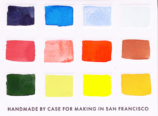 A close-up of the pre-painted swatch card for the 12-Color Watercolor Remix Travel Palette.