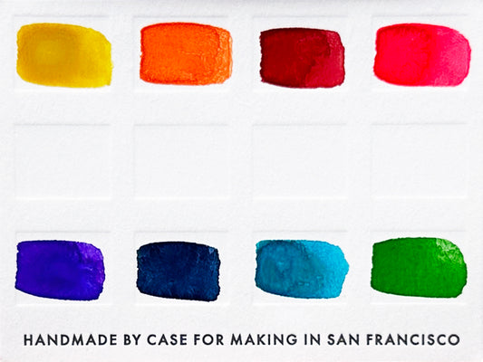 A close-up of the pre-painted swatch card for the 8-Color Rainbow Watercolor Travel Palette.