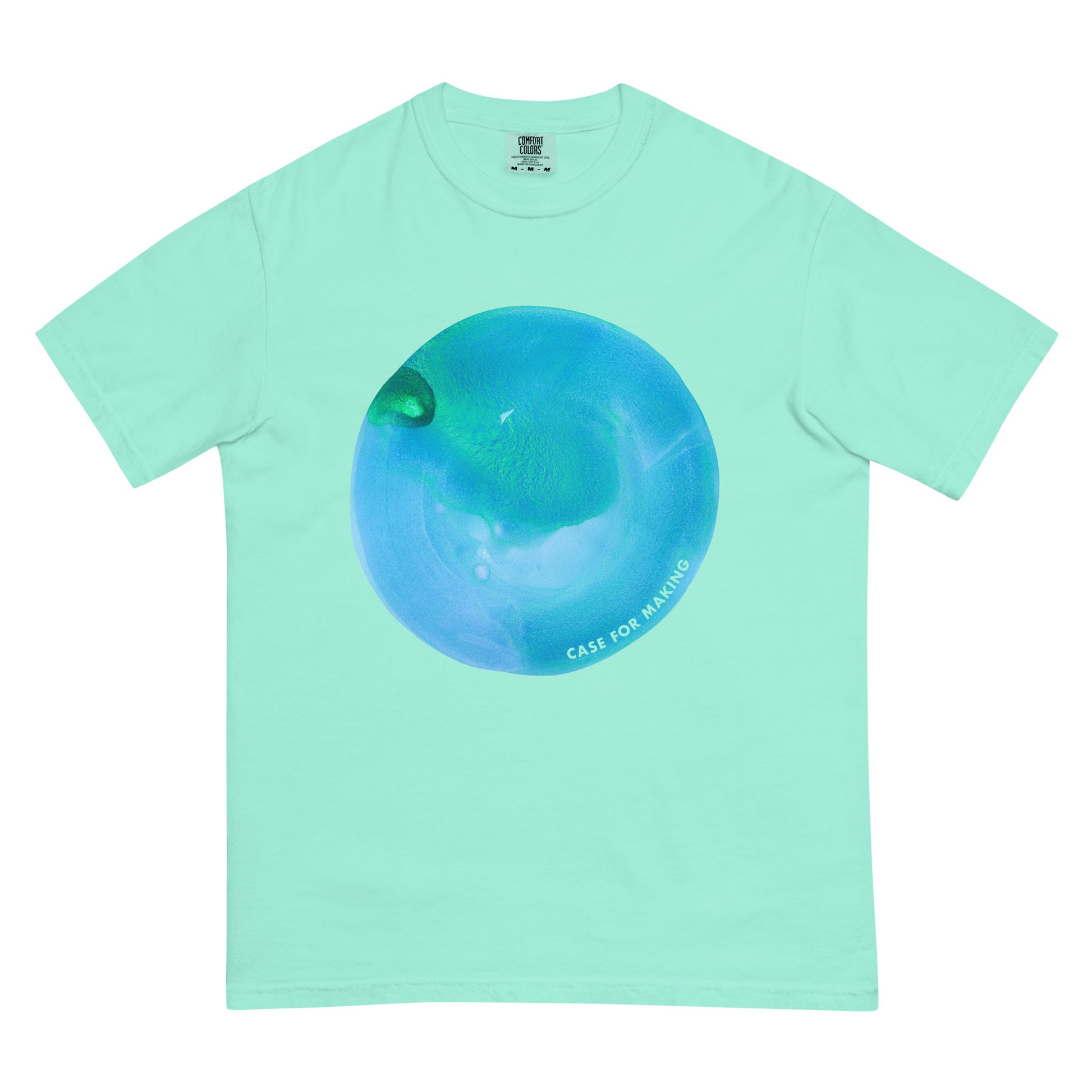 The CfM Topaz Circle Swatch Tee, a Comfort Colors t-shirt printed with a large circle swatch of CfM Topaz watercolor paint.