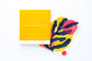 Case for Making Greeting Cards for Watercolor Pack.  Six stacked white cold press watercolor folded cards with accompanying white envelopes.  Packaged and wrapped in a golden yellow band of paper with the branding printed in white.  Also shown is a sample card with a painting on the cover.
